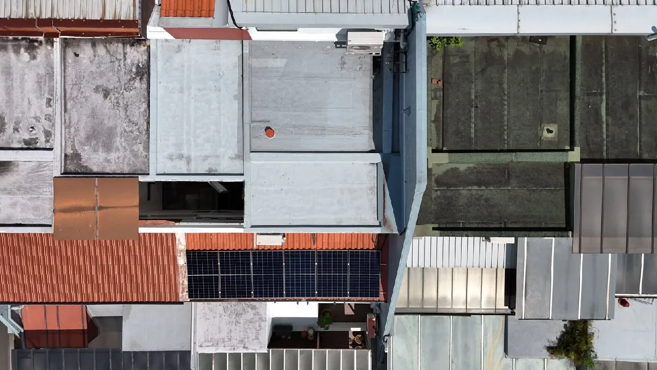Top-down drone view of a Singapore courtyard house with rooftop solar installation