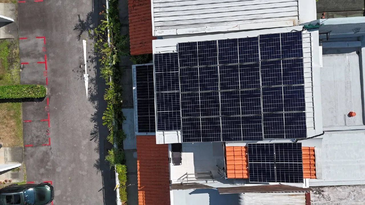 Large rooftop solar panel array on a Singapore landed home, aerial drone view